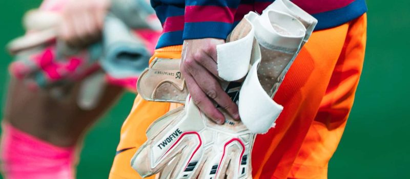 Gardiennes de football qui marchent en tenant leurs gants dans la main